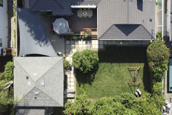 High-end real estate photography drone view over a family home in West Los Angeles, CA. by Tom Hunter Photography